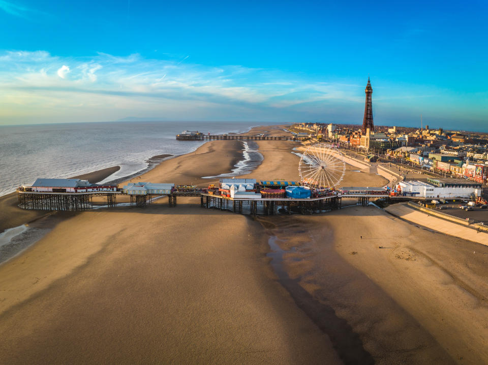 An aerial photograph of Blackpool Beach and Tower. The photograph shows North and Central Piers and the famous Blackpool Tower. The photograph was produced on a gloriously sunny day with blue skies which enhanced the golden no colour of the sandy beach.