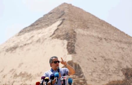 Egypt's Antiquities Minister Khaled El-Enany speaks in front of the Bent Pyramid of Sneferu that was reopened after restoration work, in Dahshur, south of Cairo