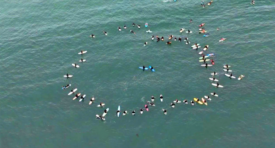 Friends, family and loved ones of the group have paid tribute in an emotional paddle-out in San Diego. 