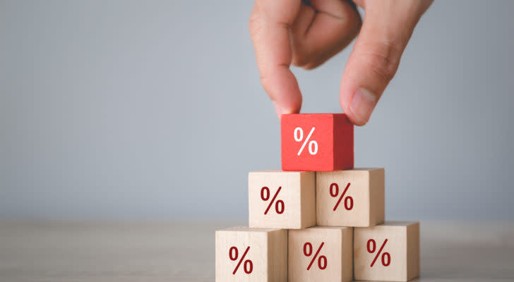 Percentage symbols on wooden cubes stacked in a triangle. The top cube is red. high-yield dividend stocks