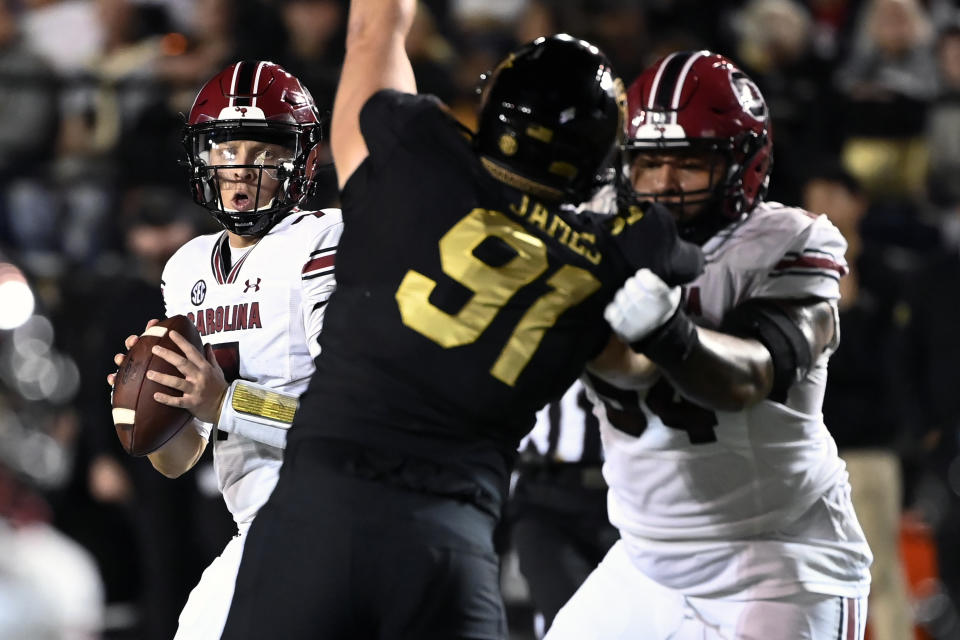 South Carolina quarterback Spencer Rattler, left, looks to pass against Vanderbilt in the first half of an NCAA college football game Saturday, Nov. 5, 2022, in Nashville, Tenn. (AP Photo/Mark Zaleski)