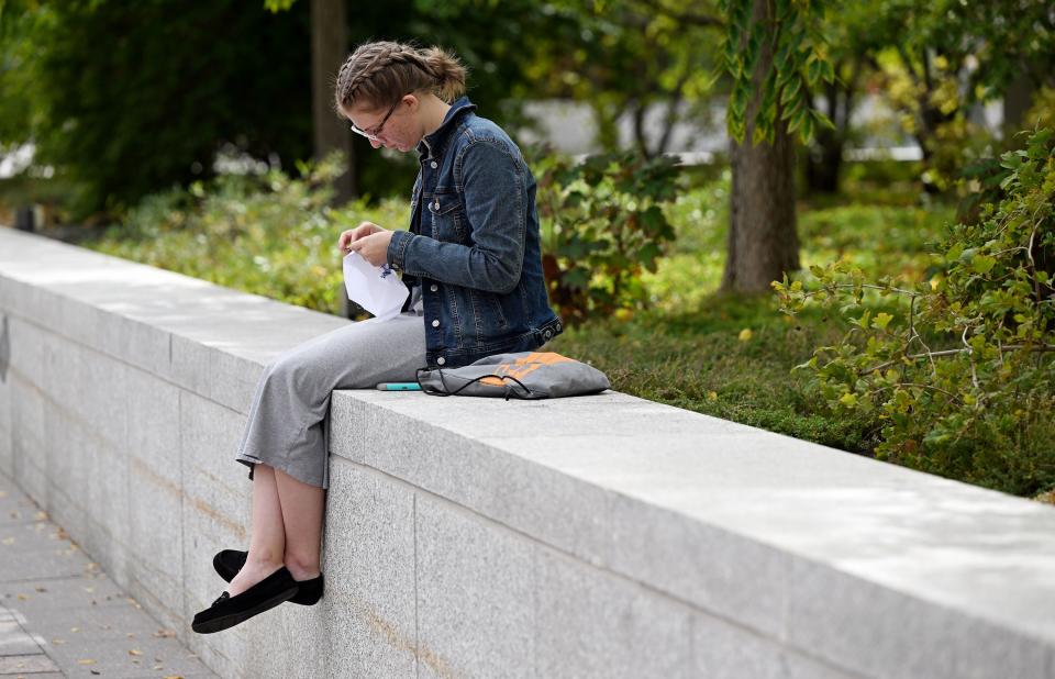 Savannah Lancaster does a cross-stitch of the Atonement as she sits outside and listens during the Saturday afternoon session of the 193rd Semiannual General Conference of The Church of Jesus Christ of Latter-day Saints at the Conference Center in Salt Lake City on Saturday, Sept. 30, 2023. | Scott G Winterton, Deseret News