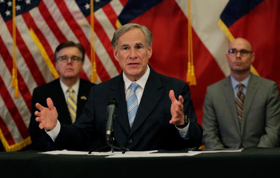 Texas Gov. Greg Abbott, flanked by Lt. Gov. Dan Patrick, left, and Texas House Speaker Dennis Bonnen, announces he'll relax restrictions imposed on businesses during the COVID-19 pandemic on April 27 in Austin, Texas.