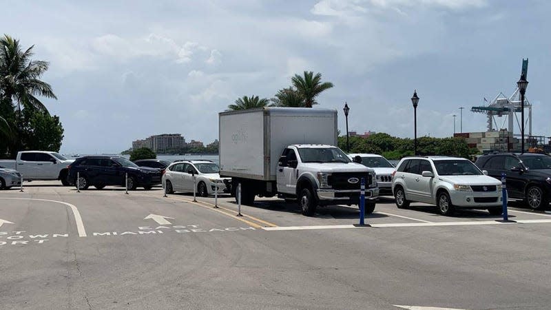 Cars line up on a Florida road waiting for a car ferry. 