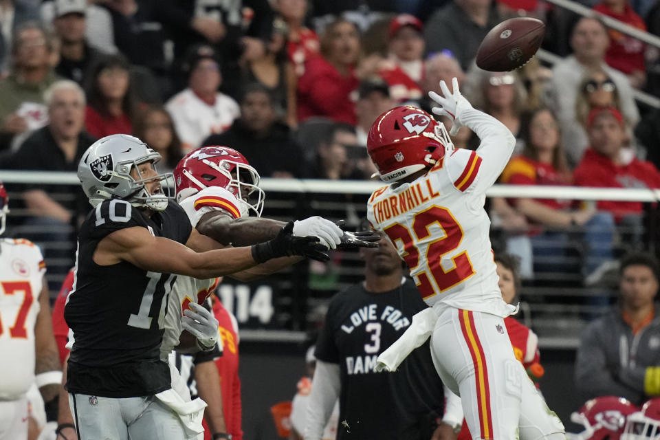 Kansas City Chiefs safety Juan Thornhill (22) intercepts a pass intended for Las Vegas Raiders wide receiver Mack Hollins (10) during the first half of an NFL football game Saturday, Jan. 7, 2023, in Las Vegas. (AP Photo/John Locher)