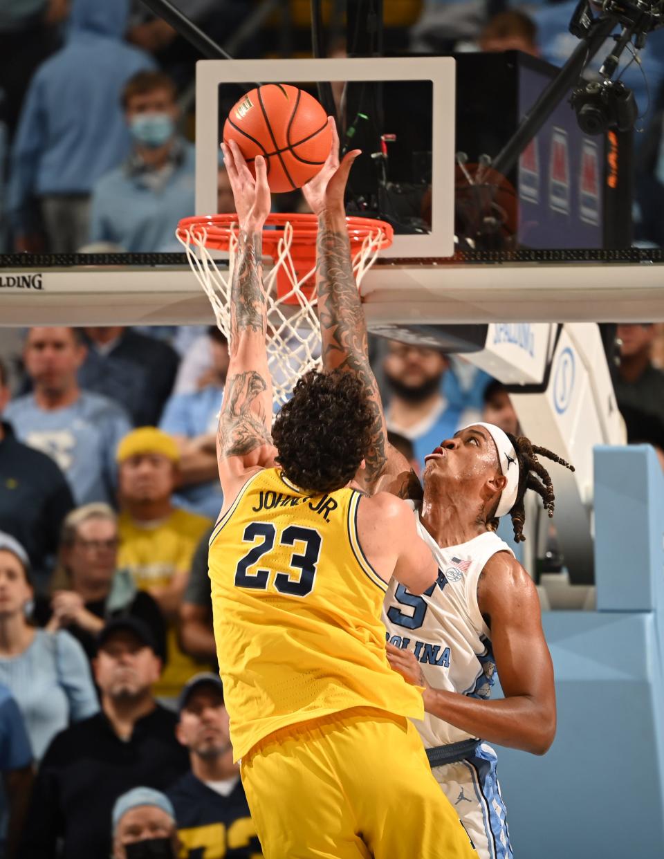 North Carolina forward Armando Bacot, right, blocks a shot by Michigan forward Brandon Johns Jr. on Wednesday night at the Smith Center.