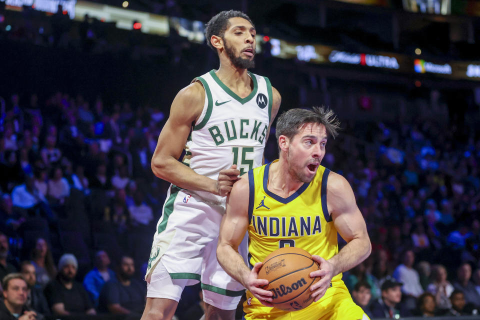 Indiana Pacers guard T.J. McConnell, right, steals a pass intended for Milwaukee Bucks guard Cameron Payne (15) during the first half of a semifinal game in the NBA basketball In-Season Tournament, Thursday, Dec. 7, 2023, in Las Vegas. (AP Photo/Ian Maule)