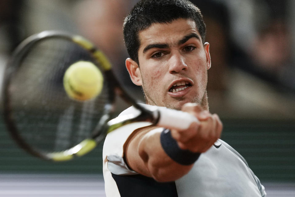 FILE - Spain's Carlos Alcaraz plays a shot against Russia's Karen Khachanov during their fourth round match at the French Open tennis tournament in Roland Garros stadium in Paris, France, Sunday, May 29, 2022. Alcaraz will compete in the 2022 Wimbledon tennis tournament. (AP Photo/Thibault Camus, File)