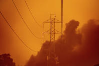 Smoke wafts past power lines as the Glass Fire burns in Santa Rosa, Calif., Monday, Sept. 28, 2020. (AP Photo/Noah Berger)