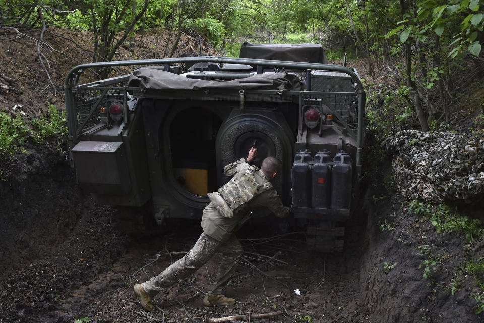 A Ukrainian serviceman with the 65th Brigade opens the door of his armored vehicle at the frontline in the Zaporizhzhia region, Ukraine, on Sunday, April 21, 2024. (AP Photo/Andriy Andriyenko)