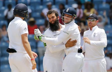 West Indies v England - Second Test - National Cricket Ground, Grenada - 25/4/15 England's Moeen Ali celebrates with Jos Buttler after taking the wicket of West Indies' Denesh Ramdin Action Images via Reuters / Jason O'Brien