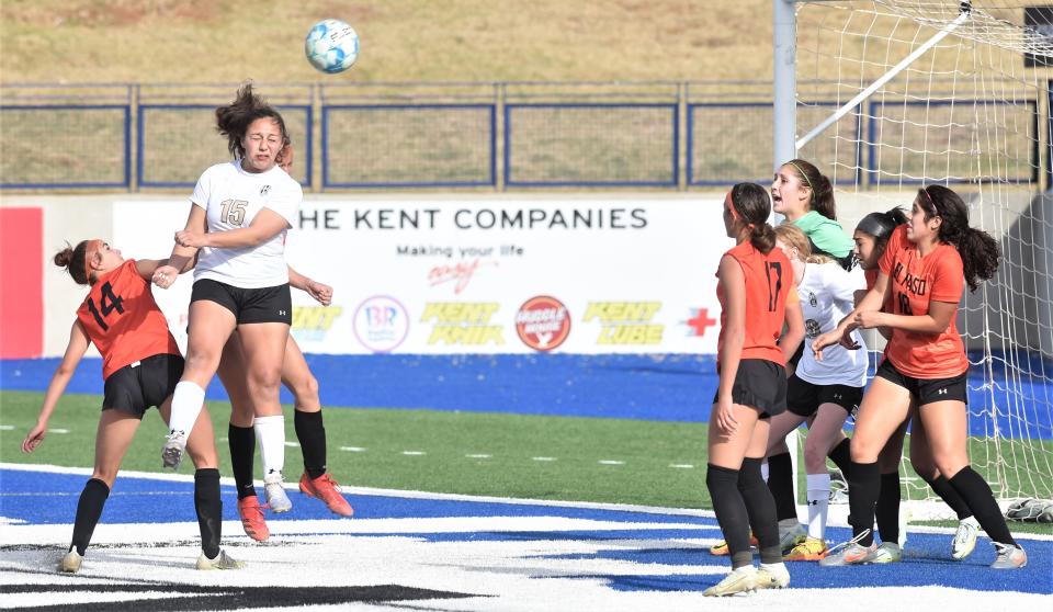 Abilene High's Justine Martinez (15) heads the ball against El Paso High.