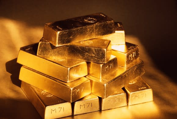 A pile of gold bars stacked four-high.