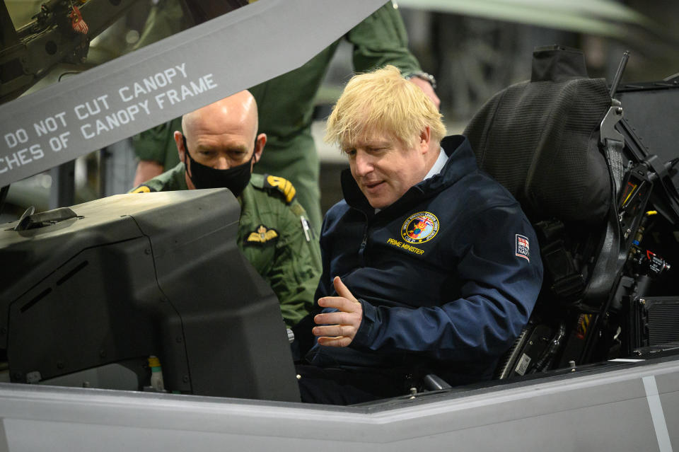 Prime Minister Boris Johnson sits in the cockpit of an Lockheed Martin F-35 Lightning II during a visit aboard HMS Queen Elizabeth in Portsmouth ahead of its first operational deployment to the Far East. Picture date: Friday May 21, 2021. (Photo by Leon Neal/PA Images via Getty Images)