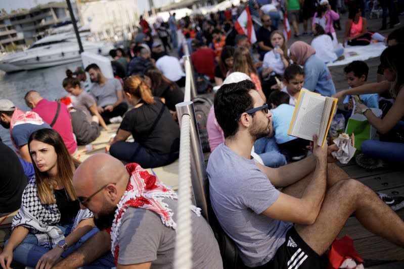 Protesters take part in the ongoing anti-government protests in Beirut