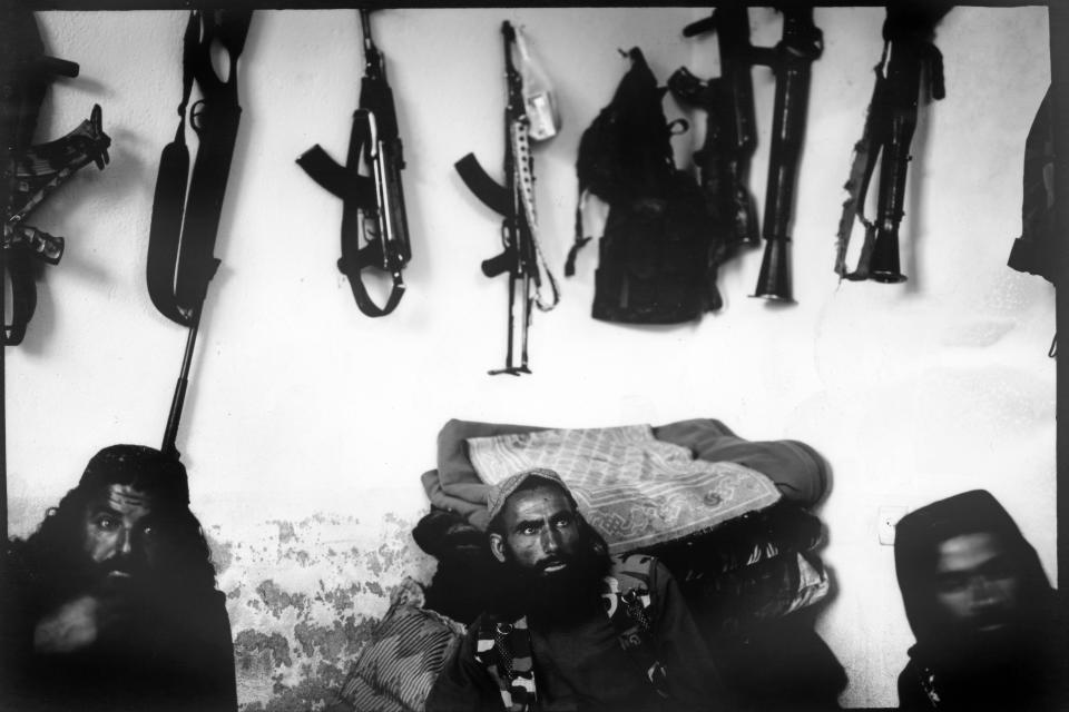 Taliban fighters gather before lunch inside an adobe house used to rest near their makeshift checkpoint in Wardak province, Afghanistan, Thursday, June 22, 2023. (AP Photo/Rodrigo Abd)