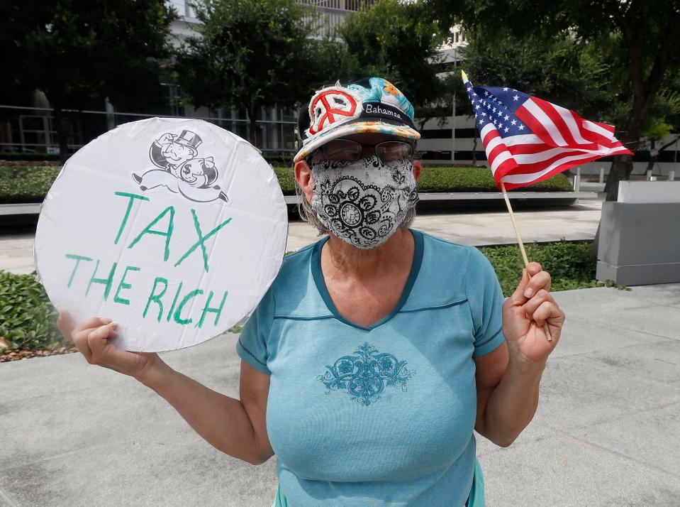 An activist calls for higher taxes for the ultra-rich and corporations in Houston, Texas in 2021.