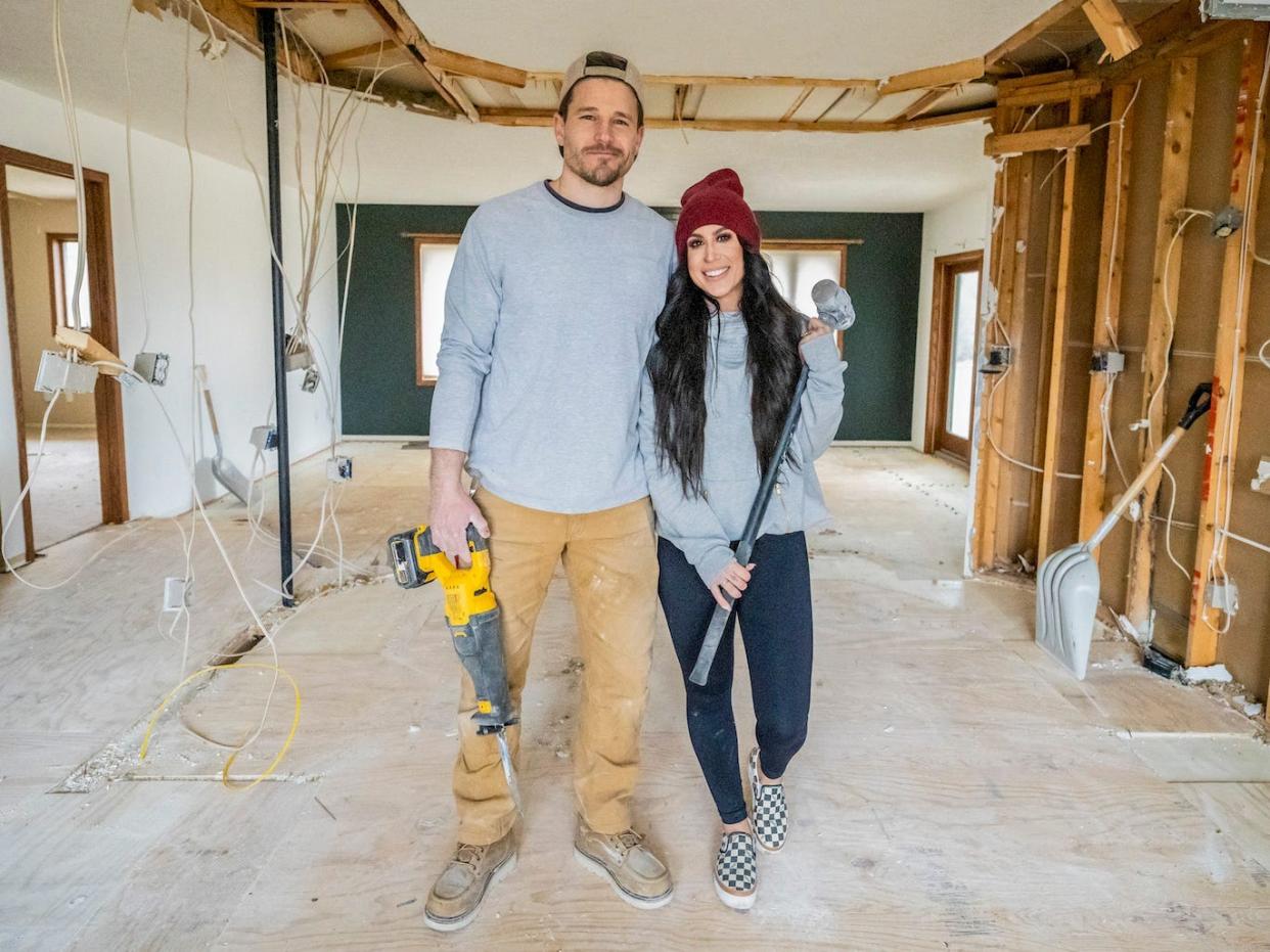 Cole and Chelsea DeBoers pose in a home that's being renovated.