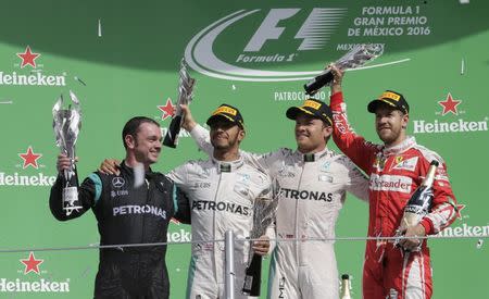 Formula One - F1 - Mexican F1 Grand Prix - Mexico City, Mexico - 30/10/16 - Paddy Lowe, engineer, technical director of Mercedes, race winning Mercedes driver Lewis Hamilton of Britain, second placed finisher Mercedes driver Nico Rosberg of Germany and third placed finishing Ferrari driver Sebastian Vettel of Germany (L to R) celebrate during the victory ceremony after the race. REUTERS/Henry Romero