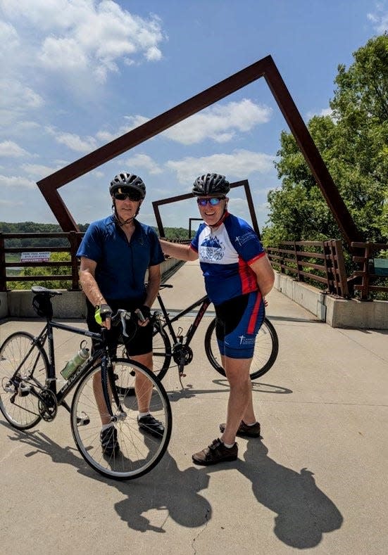 Gary Landers, left of Cincinnati, with his brother Scott Landers of Denver, traveled to Iowa to ride the High Trestle Trail in July 2020. An Ankeny study says 45,000 out-of-state visitors a year come to ride the trail, with its signature high bridge.