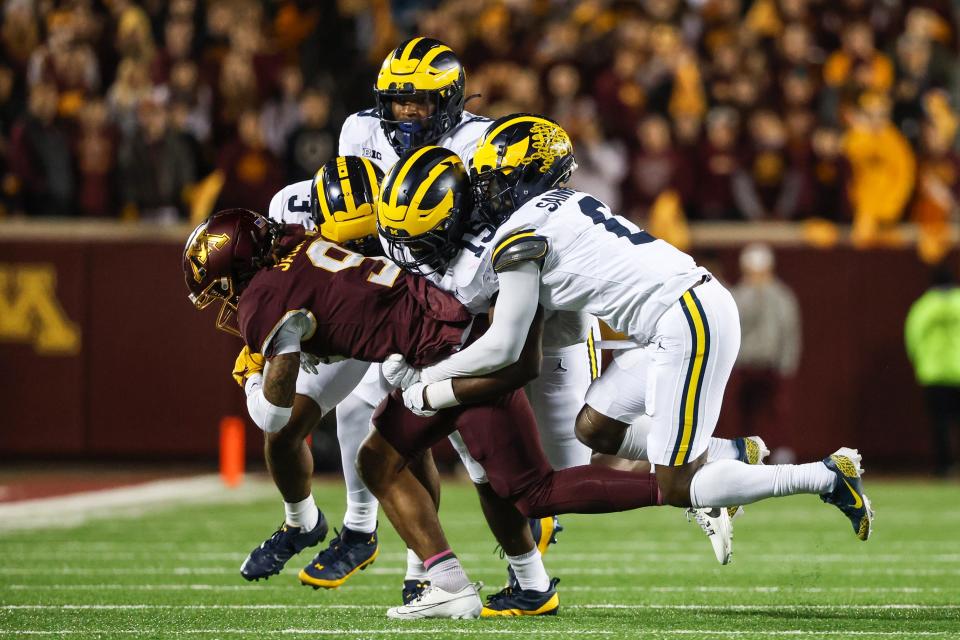 Minnesota Golden Gophers wide receiver Daniel Jackson (9) is tackled by a crowd of Michigan Wolverines during the second quarter at Huntington Bank Stadium in Minneapolis on Saturday, Oct. 7, 2023.