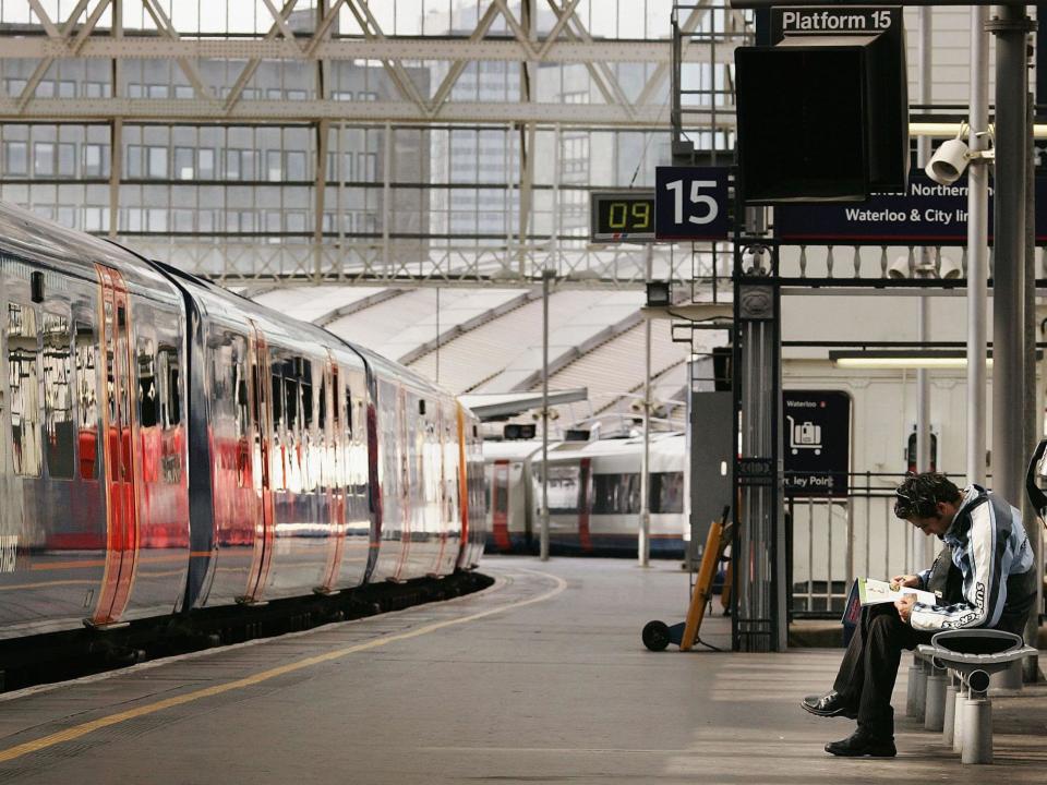 A passenger waits for a train to depart from Waterloo railway station: Getty Images