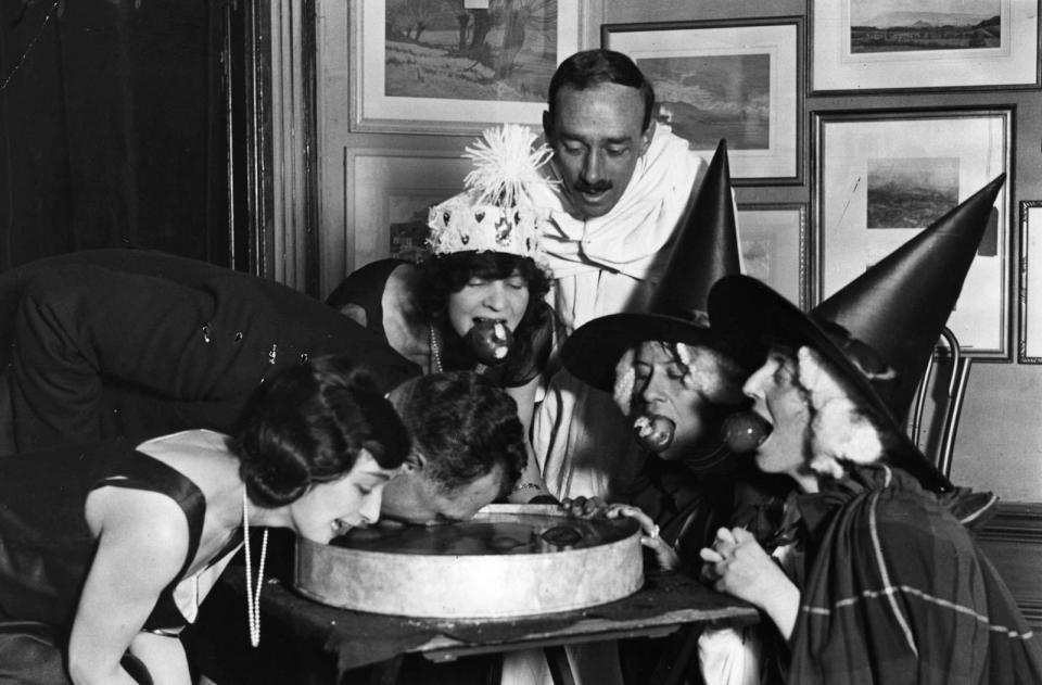 <p>These witches are bobbing for apples at a fancy Halloween party in 1922.</p>