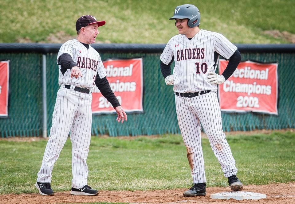 Wapahani baseball head coach Brian Dudley (left) talks with junior Daxton Dudley during their game against Muncie Central at Wapahani High School Saturday, April 2, 2022.