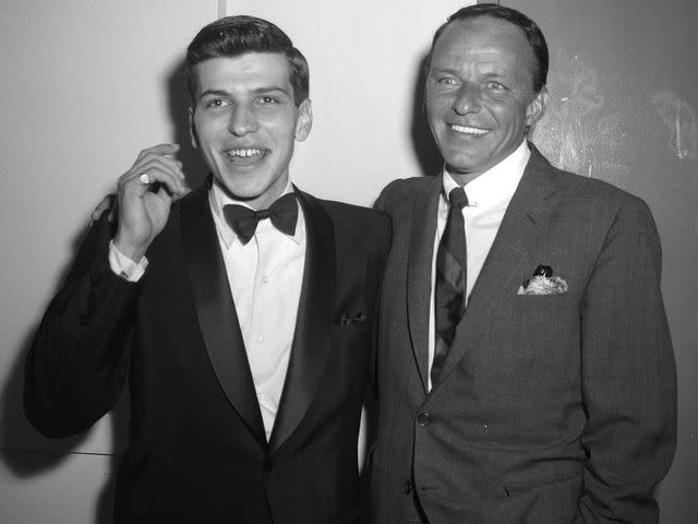 <p>Jim Mooney/NY Daily News/Getty</p> Frank Sinatra Jr, and Frank Sinatra Sr. at the Hotel Americana, following Jr's performance at "The Royal Box".