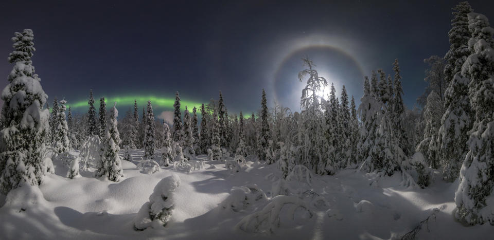 <p>In a series of stunning images, Vitaly Istomin managed to capture the aurora borealis streaking in waves across the sky, with a bright moon lighting up the snow below. (Photo: Vitaly Istomin/Caters News) </p>