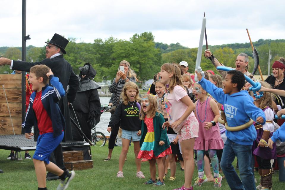 Led by festival organizer Scott MacKenzie, young pirates yell a battle cry at the Battle of Boyne River at Boyne City's Pirate Fest in 2023.