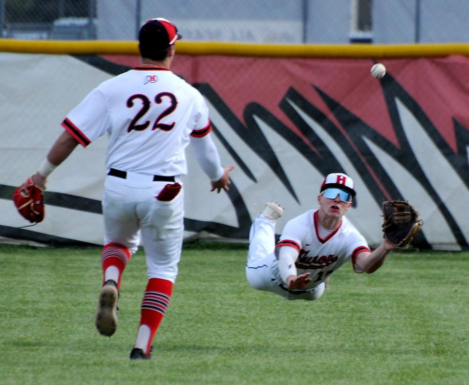 Centerfielder Miles Grace of Huron laid to attempt to take a hit away from Flat Rock , but the ball dropped in for a hit as Flat Rock beat Huron 7-3 Tuesday, April 11, 2023.