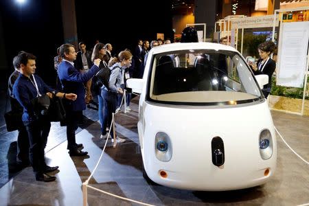 Visitors look at a self-driving car by Google displayed at the Viva Technology event in Paris, France, July 1, 2016. REUTERS/Benoit Tessier