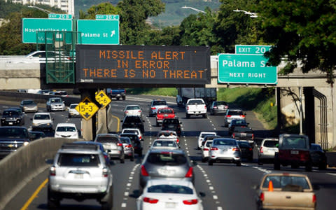 A highway sign says "MISSILE ALERT ERROR THERE IS NO THREAT" on the H-1 Freeway in Honolulu - Credit: AP