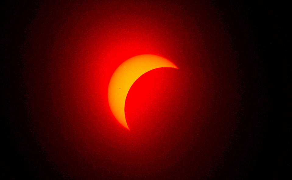 The sun is eclipsed by the moon above Fort Worth, Texas.