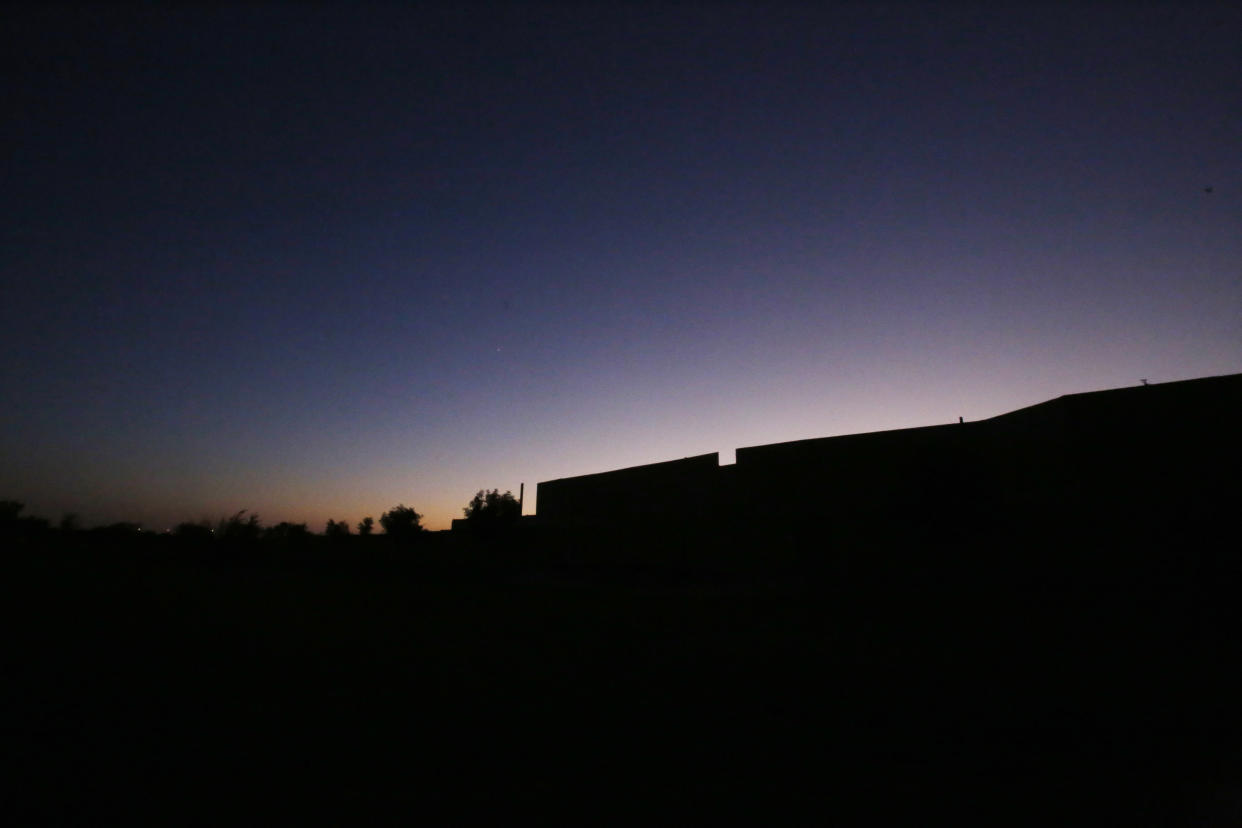 The sun sets behind a natural gas drilling site in Arlington, Texas, on Sunday, Oct. 24, 2021. The site, called "Rocking Horse," is operated by TEP Barnett, a subsidiary of French energy giant Total Energies. It is one of the company's 33 drill sites in Arlington that have a total of 163 wells, most of them tucked within urban neighborhoods. Arlington sits above the Barnett Shale, a geological formation rich with natural gas that is released by hydraulic fracturing, also known as fracking. (AP Photo/Martha Irvine)