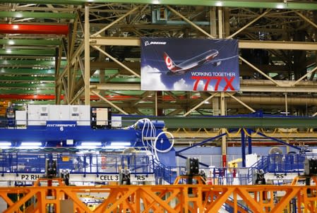 A large 777X banner is seen hanging over the Boeing 777X Final Assembly Building floor during a media tour of Boeing production facilities in Everett