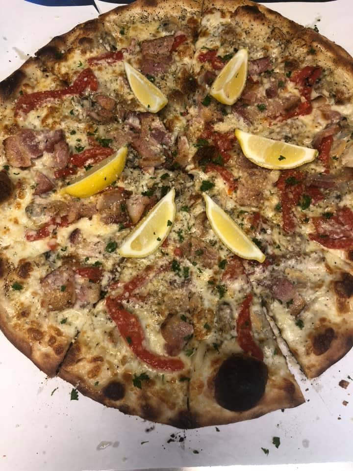 Fantini's New Haven Style Apizza opened in Stuart in late February 2020 featuring signature pies such as the White Clam Casino (pictured), with top neck clams, bacon, roasted sweet red peppers, fresh garlic, oregano, extra virgin olive oil, and imported romano grated cheese.