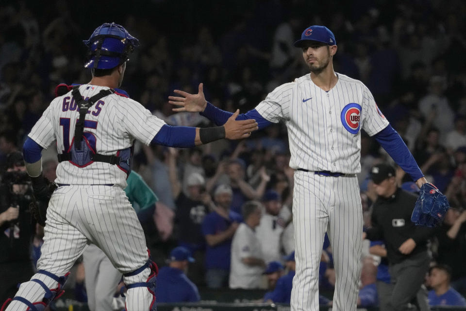Chicago Cubs relief pitcher Julian Merryweather, right, celebrates with catcher Yan Gomes after the Cubs defeated the Seattle Mariners 14-9 in a baseball game in Chicago, Tuesday, April 11, 2023. (AP Photo/Nam Y. Huh)
