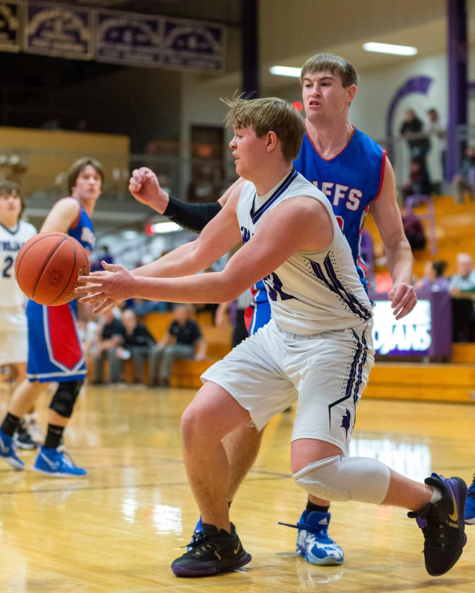 Southeast of Saline's Caden Isaacson (32) looks for an open man under the basket in Tuesday's 53-31 Trojan home victory over Republic County.