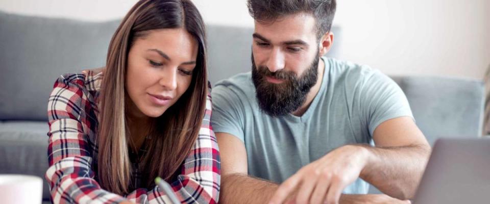 Family, debts and financial problems. Young husband and wife doing paperwork together, calculating their expenses.