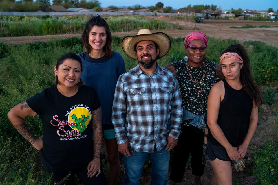 From left, Chef Maria Parra Cano, Ali LoPiccolo, Brian Cano, Nelli Evans, Alexis Ruby Trevizo, pose for a group portrait at Food Forest Cooperative on March 17, 2022, in Phoenix. The farm co-op is a 1.5-acre plot of land located on Spaces of Opportunity in south Phoenix.