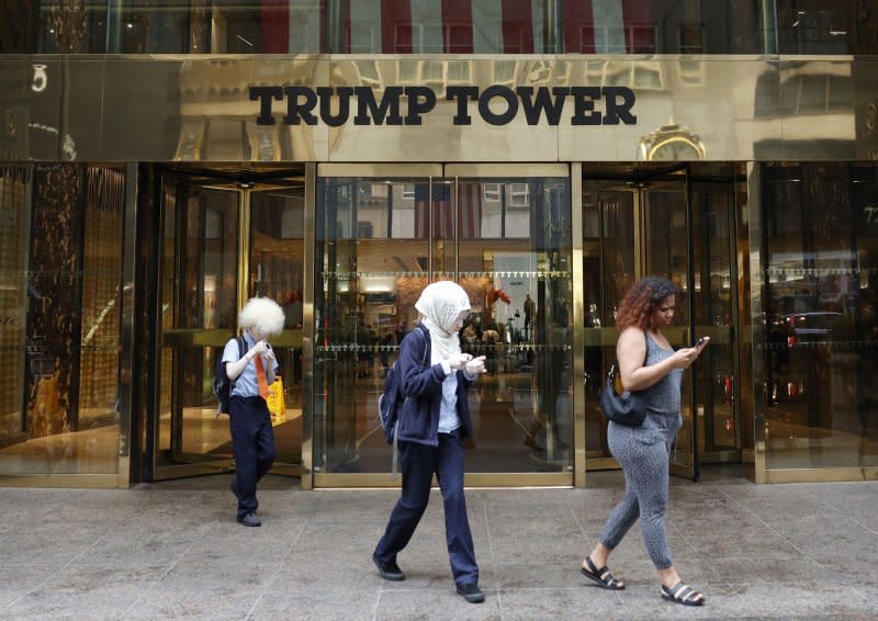 Pedestrians walk past Trump Tower on Fifth Avenue on Friday in New York City. A New York appeals judge temporarily paused the process of dissolving Trump's businesses. Photo by John Angelillo/UPI