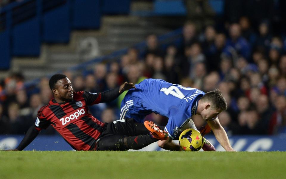 West Bromwich Albion's Stephane Sessegnon (L) challenges Chelsea's Gary Cahill during their English Premier League soccer match at Stamford Bridge in London November 9, 2013.