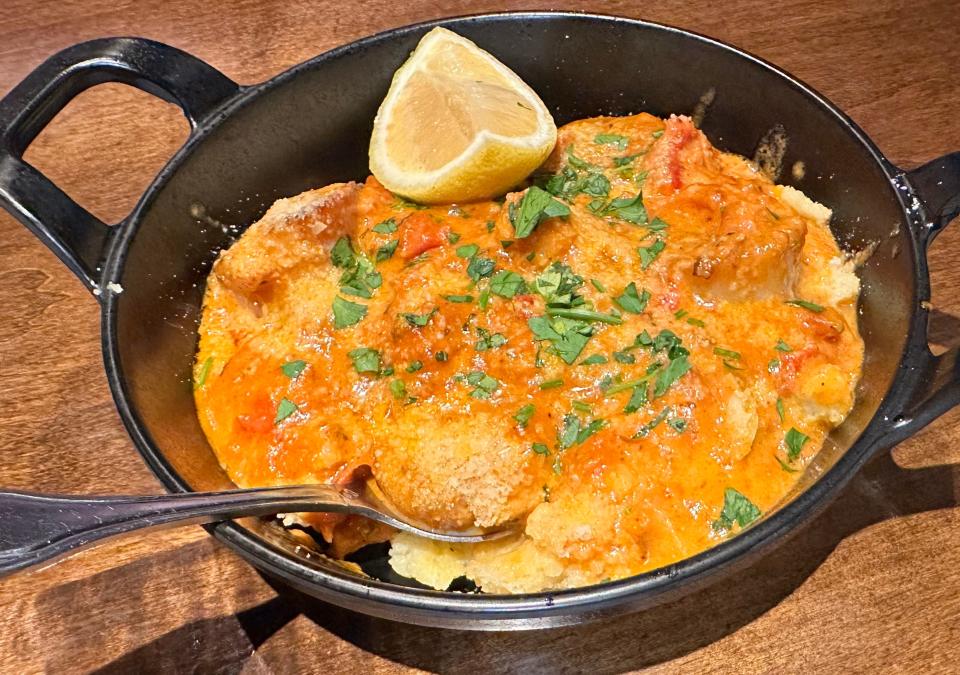 One of the pricey specials at Table Six Kitchen + Bar is seared scallops over goat cheese, with polenta, tomatoes and a cream sauce.