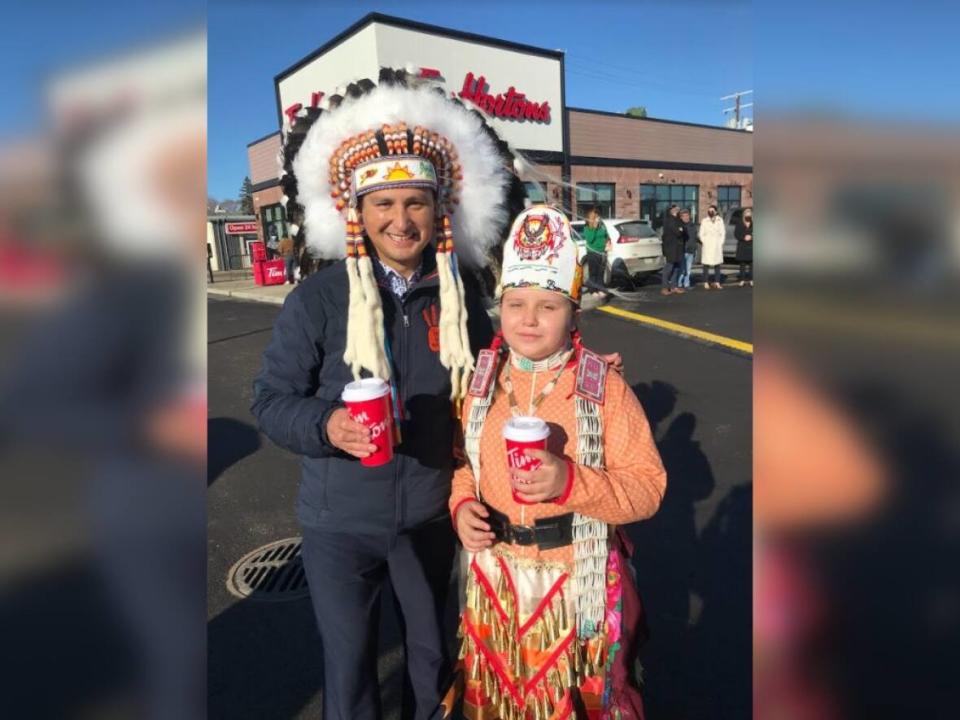 Chief Cadmus Delorme was with Mimikwas Agecoutay, Cowessess's junior powwow princess, at the grand opening of the Tim Hortons on Wednesday. (Mah Noor Mubarik/CBC - image credit)