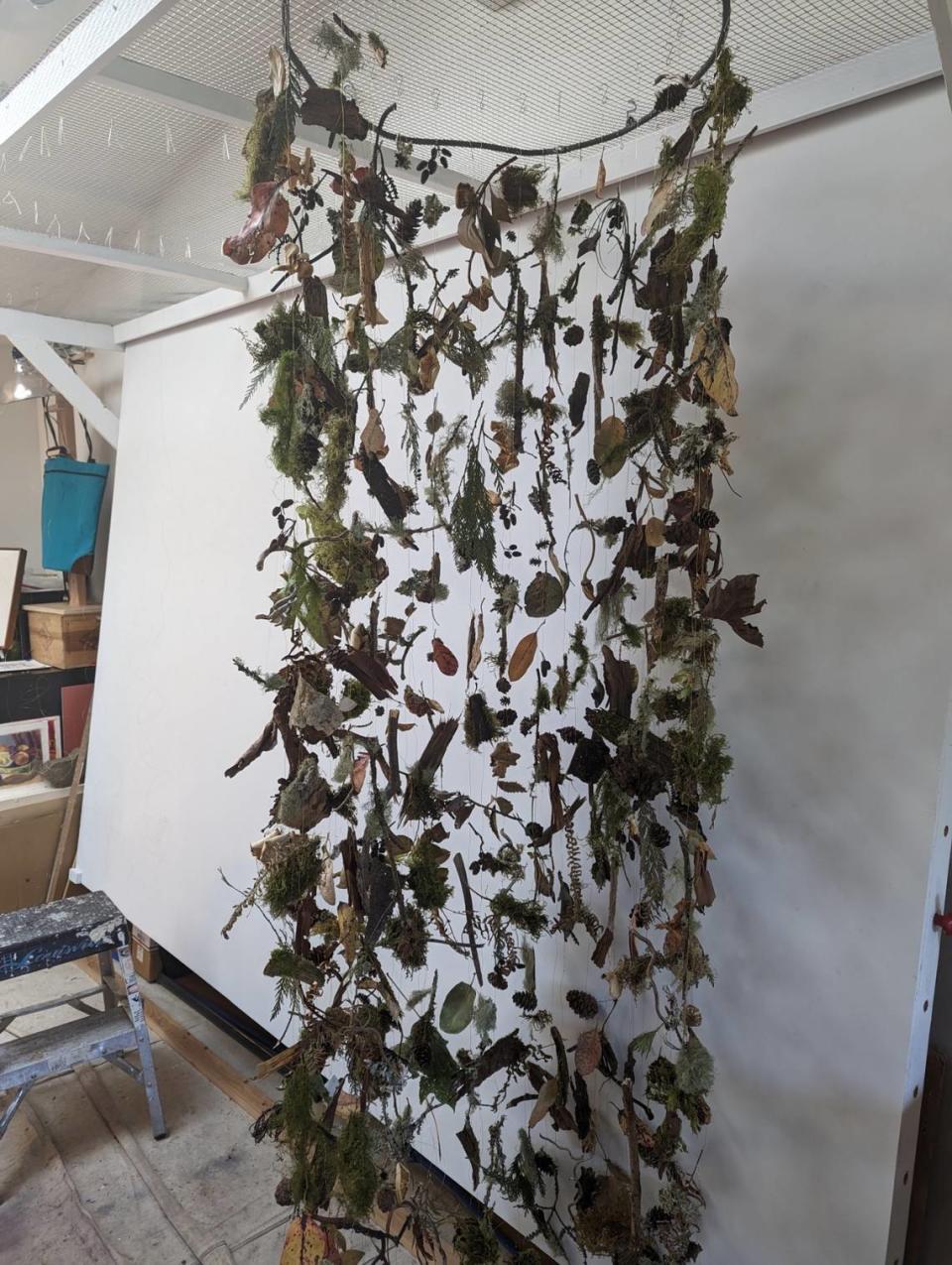 Kathy Gore-Fuss’s “Wound Wood” includes forest garlands made with help from artistic volunteers.