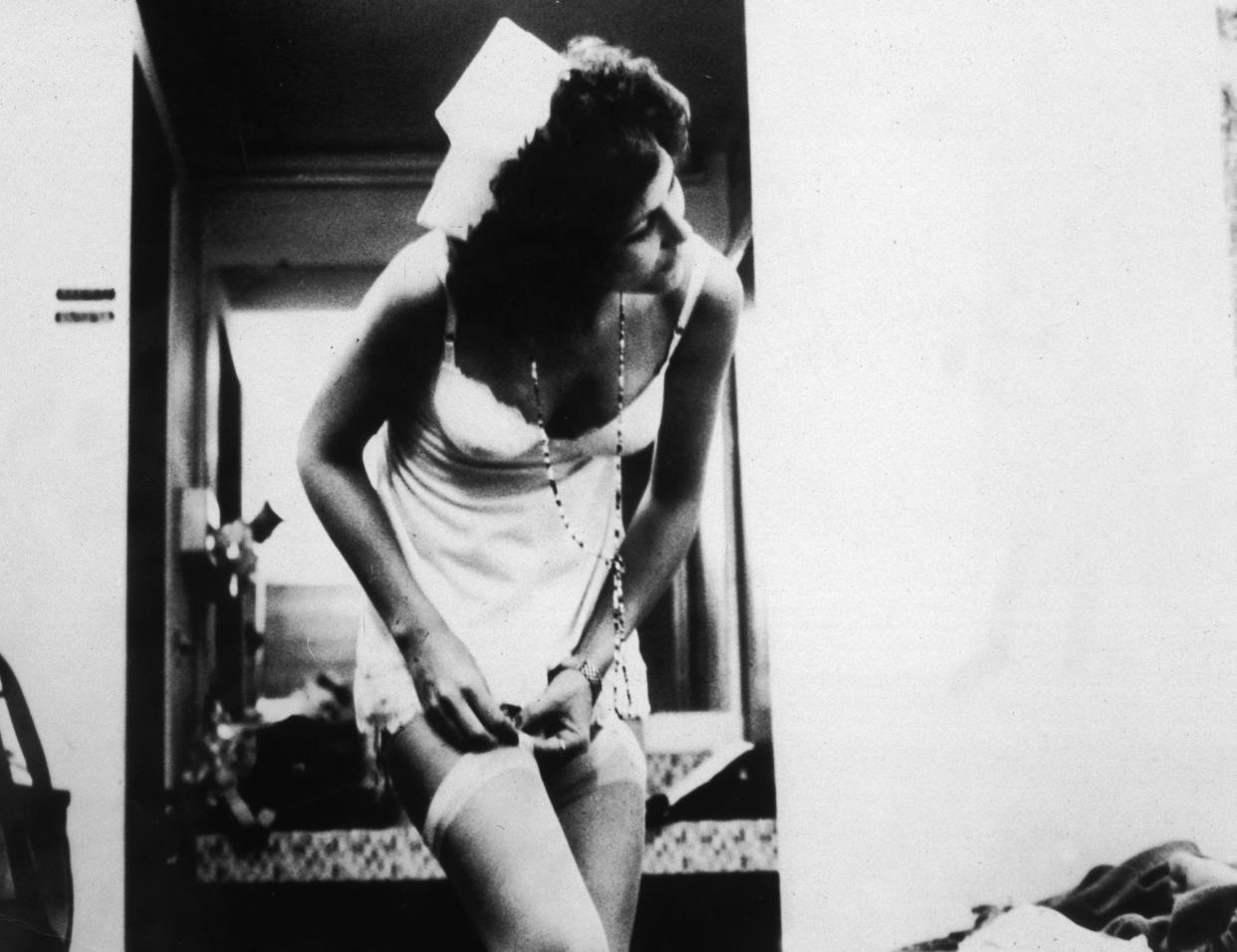 1972, American actor Linda Lovelace (1949 - 2002), as Herself, adjusts her garter in a still from director Gerard Damiano pornographic film 'Deep Throat'. (Photo by Getty Images/Getty Images)