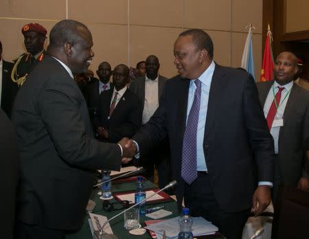 Kenya's President Uhuru Kenyatta (R) meets South Sudan Rebel leader Riek Machar during the 32nd Extra-Ordinary Summit of IGAD Assembly of Heads of State and Government in Addis Ababa, Ethiopia June 21, 2018. Presidential Press Service/Handout via REUTERS