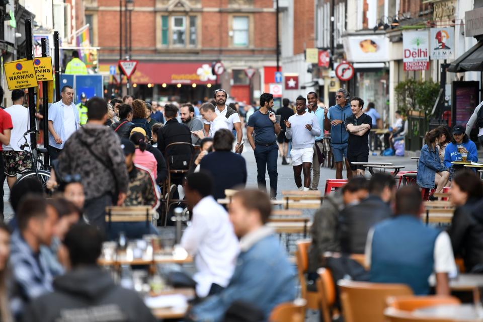 Customers sit outside re-opened bars in Soho in London on July 5, 2020, as the Soho area embraces pedestrianisation in line with an easing of restrictions during the novel coronavirus COVID-19 pandemic. - Pubs in England reopened this weekend for the first time since late March, bringing cheer to drinkers and the industry but fears of public disorder and fresh coronavirus cases. (Photo by DANIEL LEAL-OLIVAS / AFP) (Photo by DANIEL LEAL-OLIVAS/AFP via Getty Images)